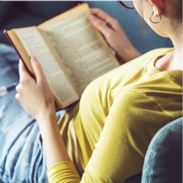 a woman sitting reading a book