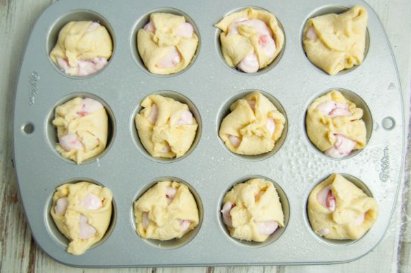Strawberry Cheesecake Puffs ready to be baked in a muffin pan