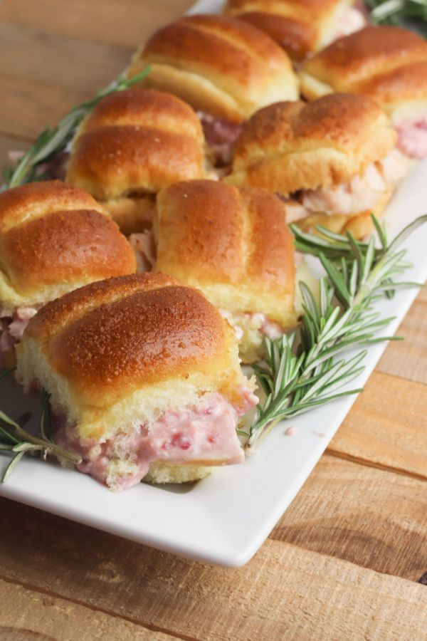 Turkey Cranberry Sliders on a white platter on a wood table