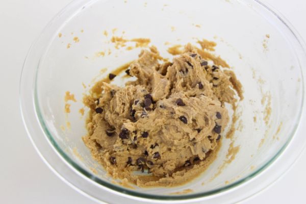 Eggless Chocolate Chip Cookie Dough in a glass mixing bowl on a white background