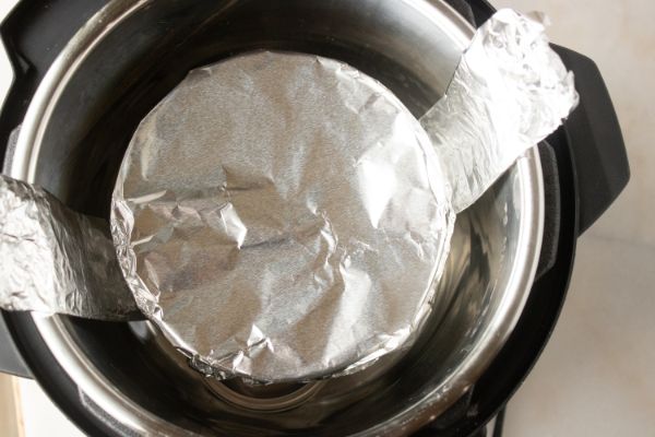 a push pan lined with a parchment round in an instant pot