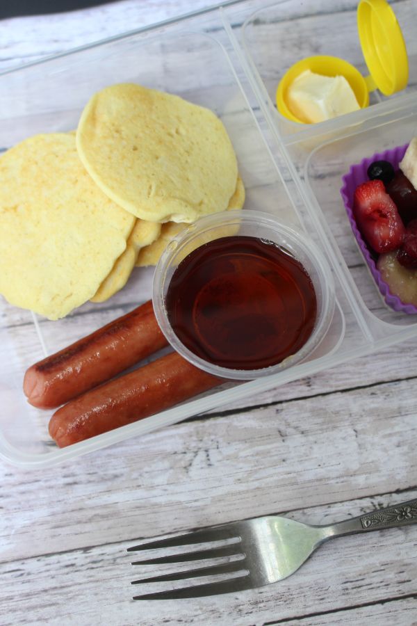 pancakes lunch box with sausage and syrup