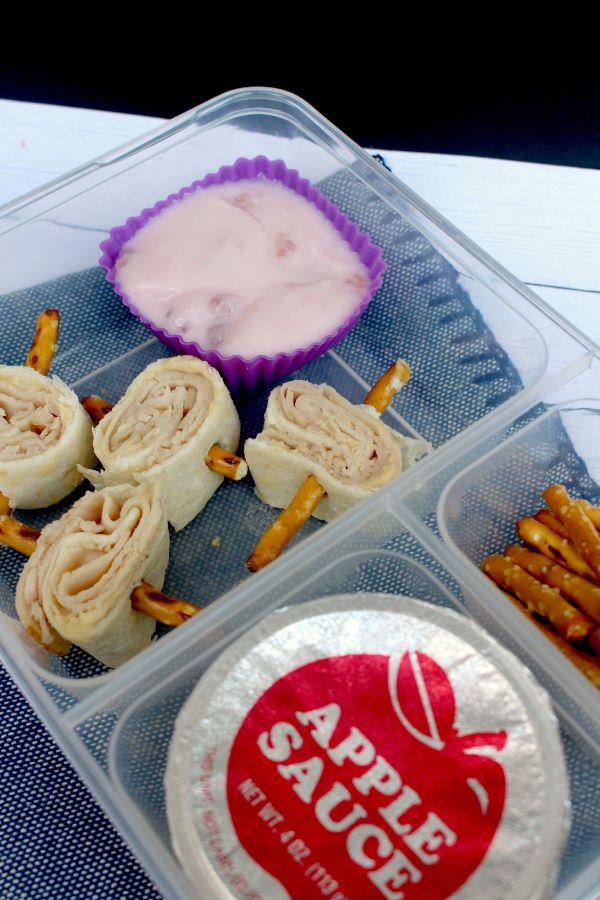 hummus pinwheels lunch box also with yogurt, apple sauce and pretzel sticks