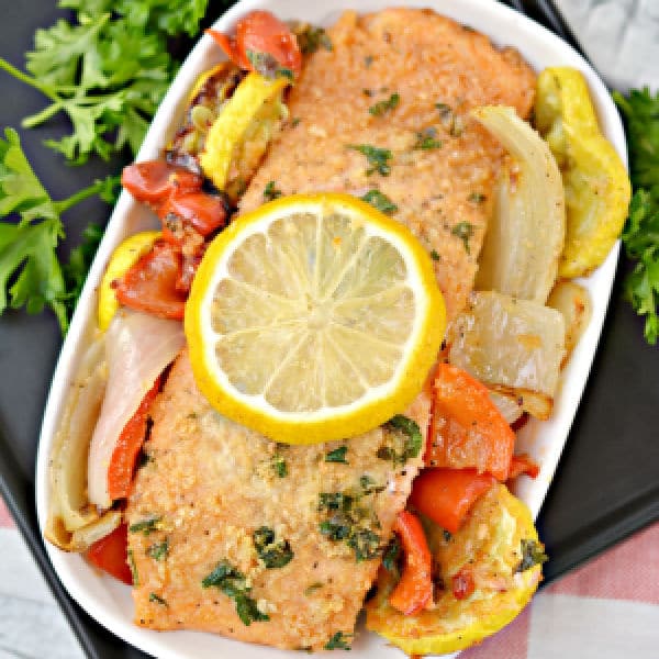 easy Keto Parmesan Crusted Baked Salmon on a white dish on a baking pan