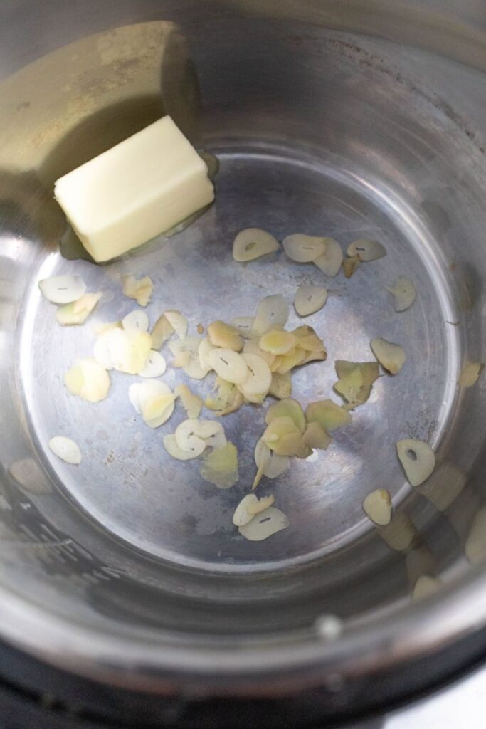 Butter, chopped ginger, and chopped garlic in an instant pot.