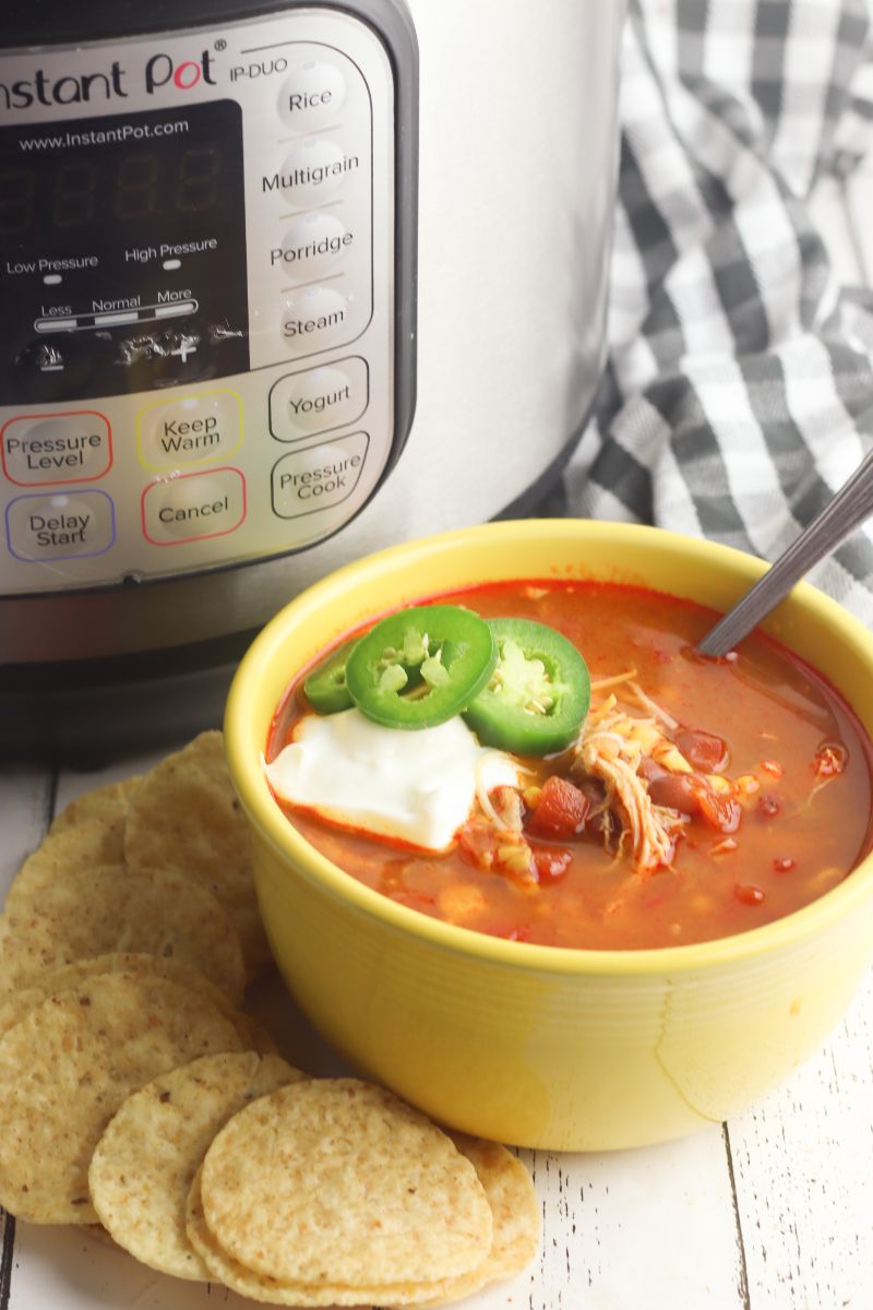 This Instant Pot Chicken Tortilla Soup is quick and easy to make at home. Loaded with the goodness of beans and vegetables, the spicy Mexican Tortilla Soup will be a hearty hit with family and friends. #easychickentortillasoup #chickentortillasoup #chickentortillasouprecipe #mexicantortillasoup #instantpotchickensoup #instantpotmexicansoup #onepotdinner #bestmexicansoup  via @wondermomwannab