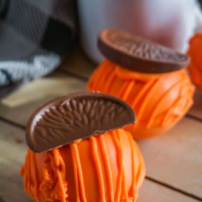 Chocolate Orange Hot Cocoa Bombs on wooden platter