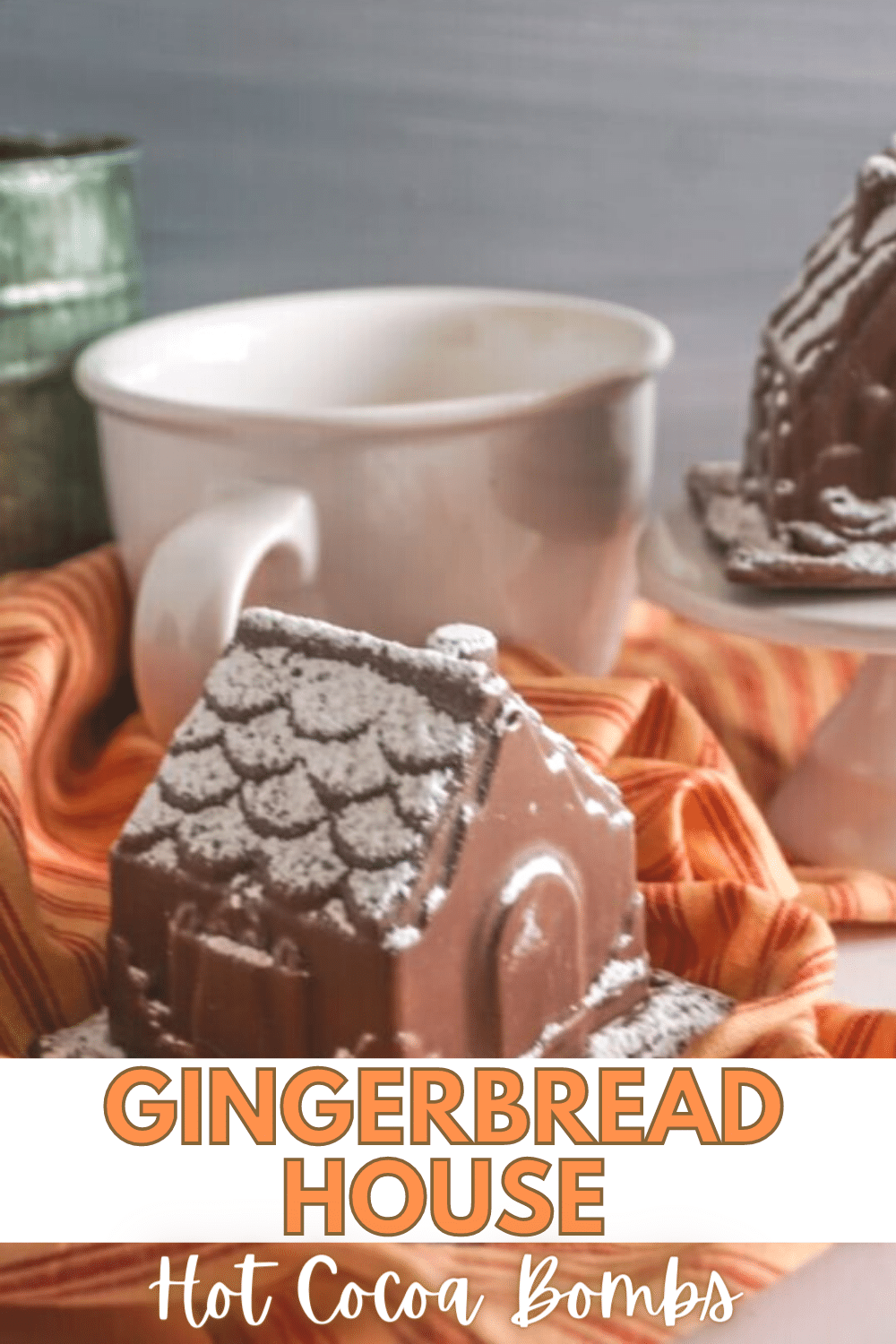 Gingerbread House Hot Cocoa Bomb next to a white mug