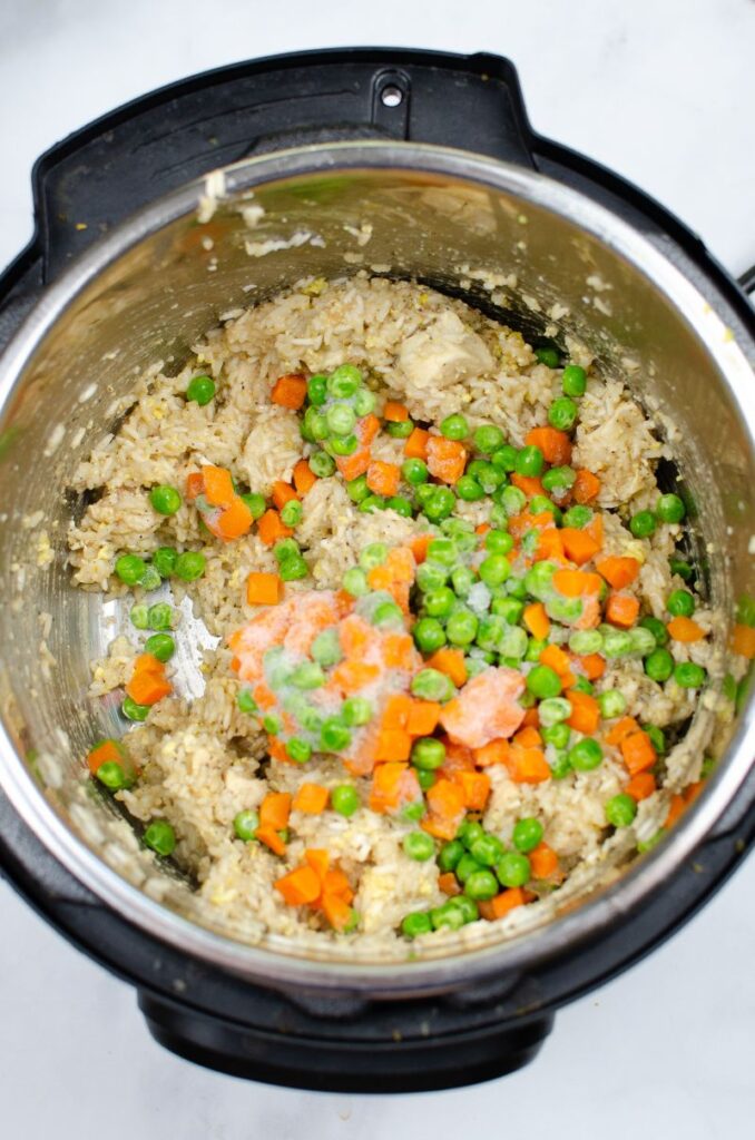 Peas, carrots, rice and chicken in an instant pot.