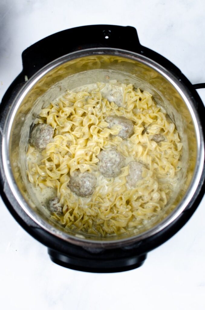 Egg noodles and turkey meatballs in an instant pot.