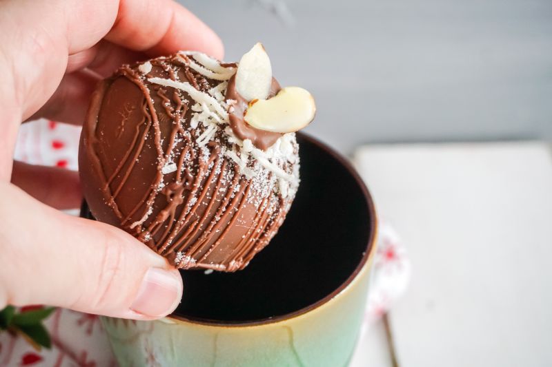 putting almond joy hot cocoa bomb in mug