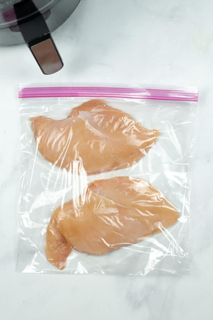 adding chicken to plastic bags