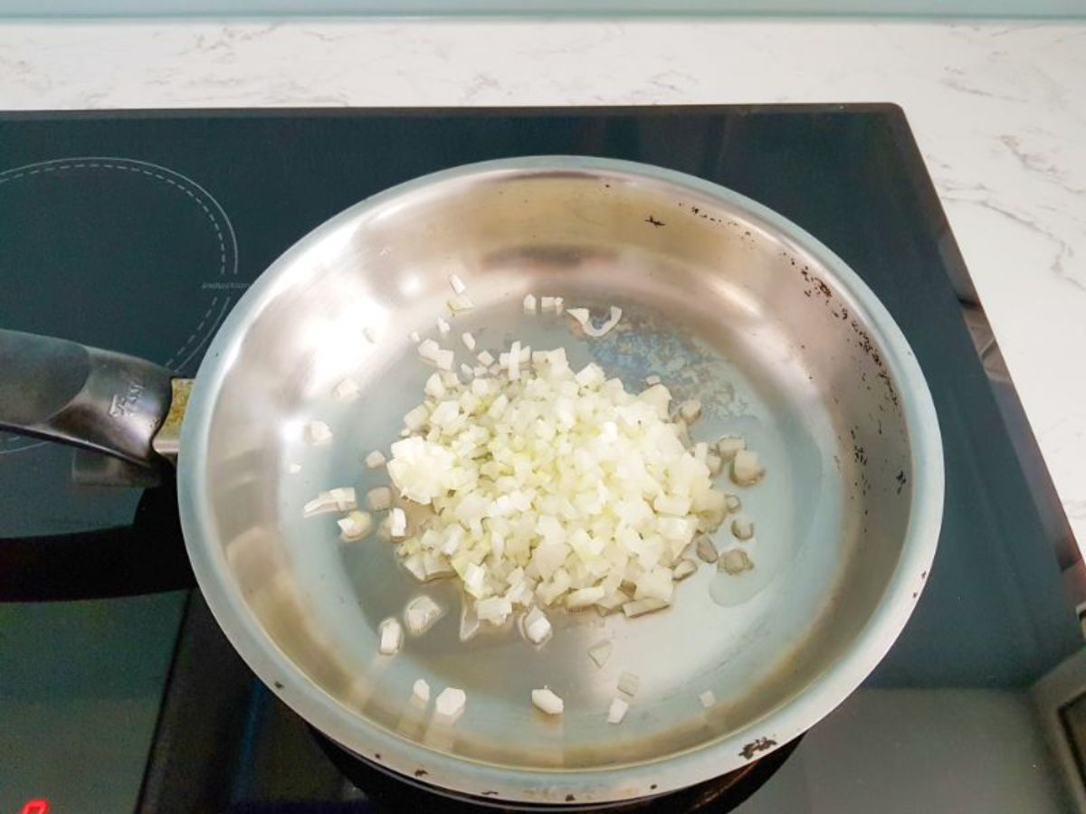 onions cooking in oil in a skillet.