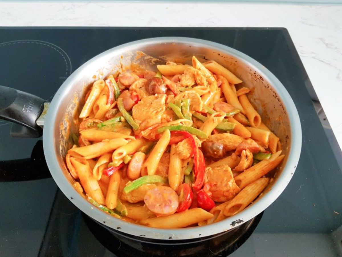 spicy chicken pasta in a skillet.