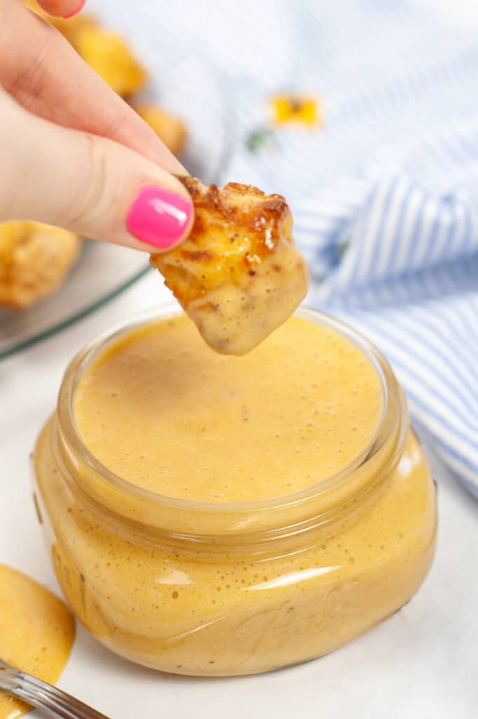 dipping chicken nugget into Copycat Chick-Fil-A Sauce 