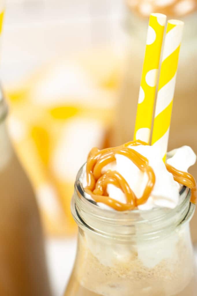 Copycat Starbucks Iced Caramel Macchiato with yellow straw close up