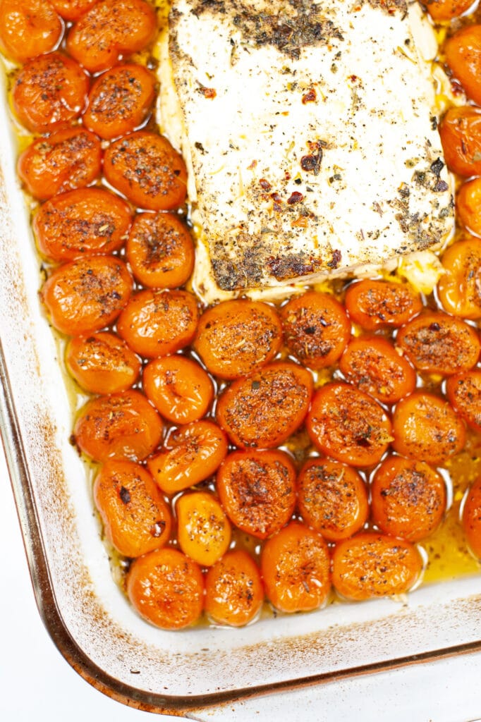 putting feta and tomatoes in the oven to bake