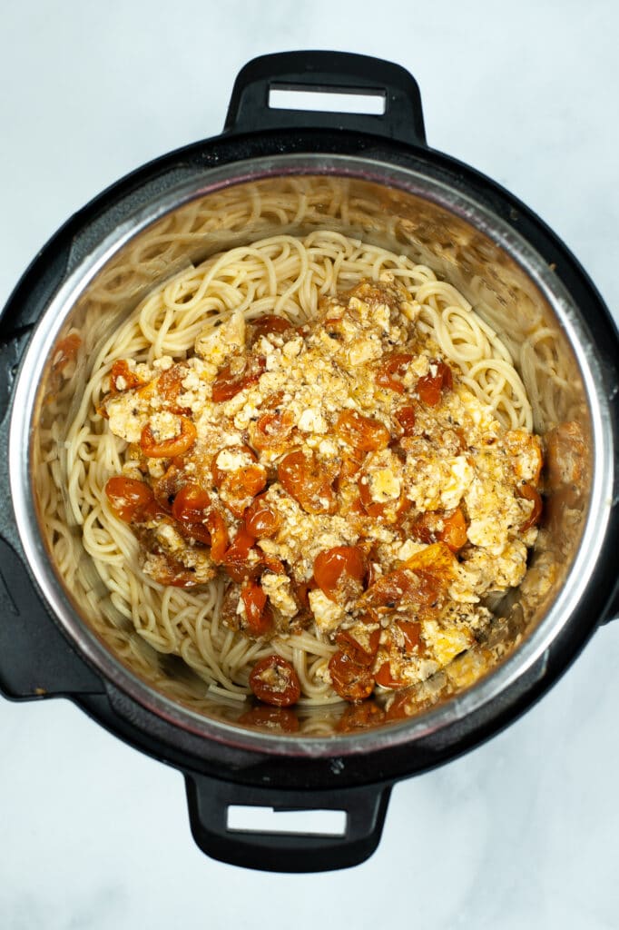 adding the noodles and pasta to the instant pot to cook