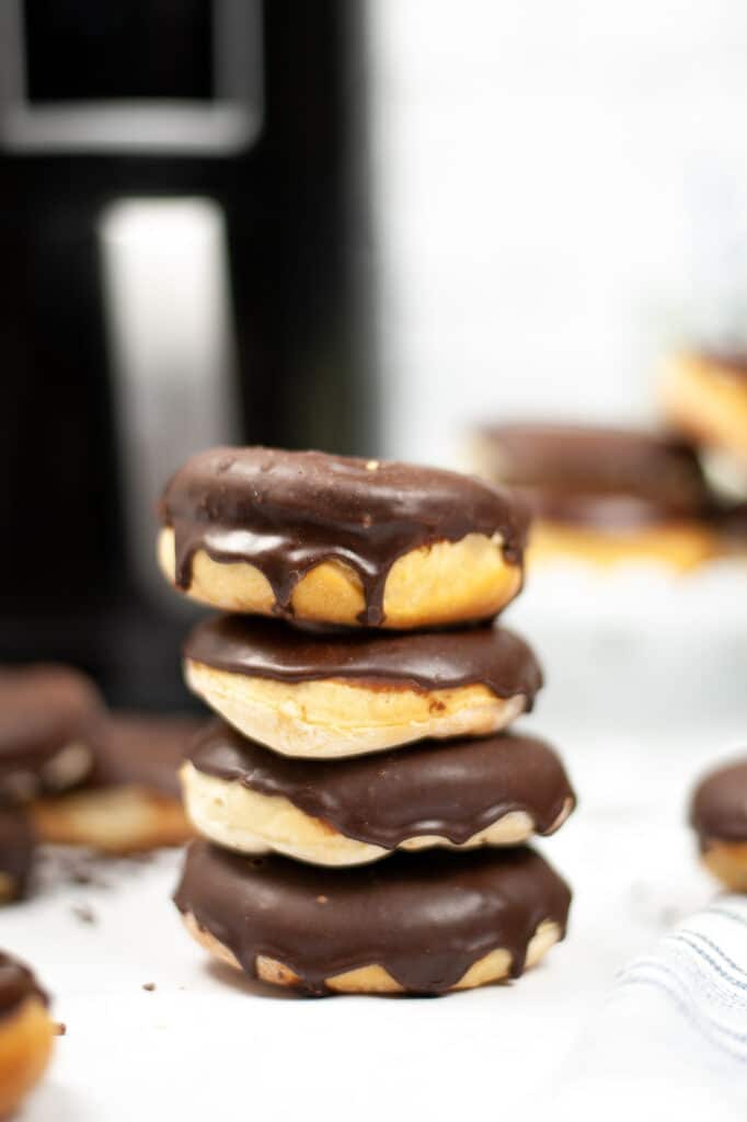 tall stack of chocolate glazed donuts 