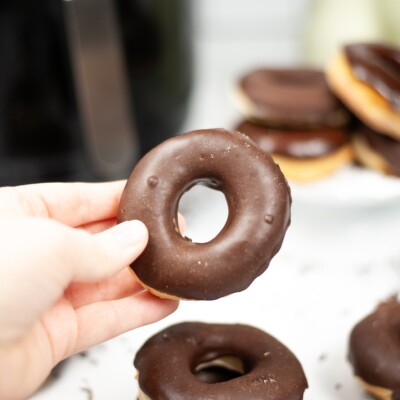 hand holding a chocolate glazed donut