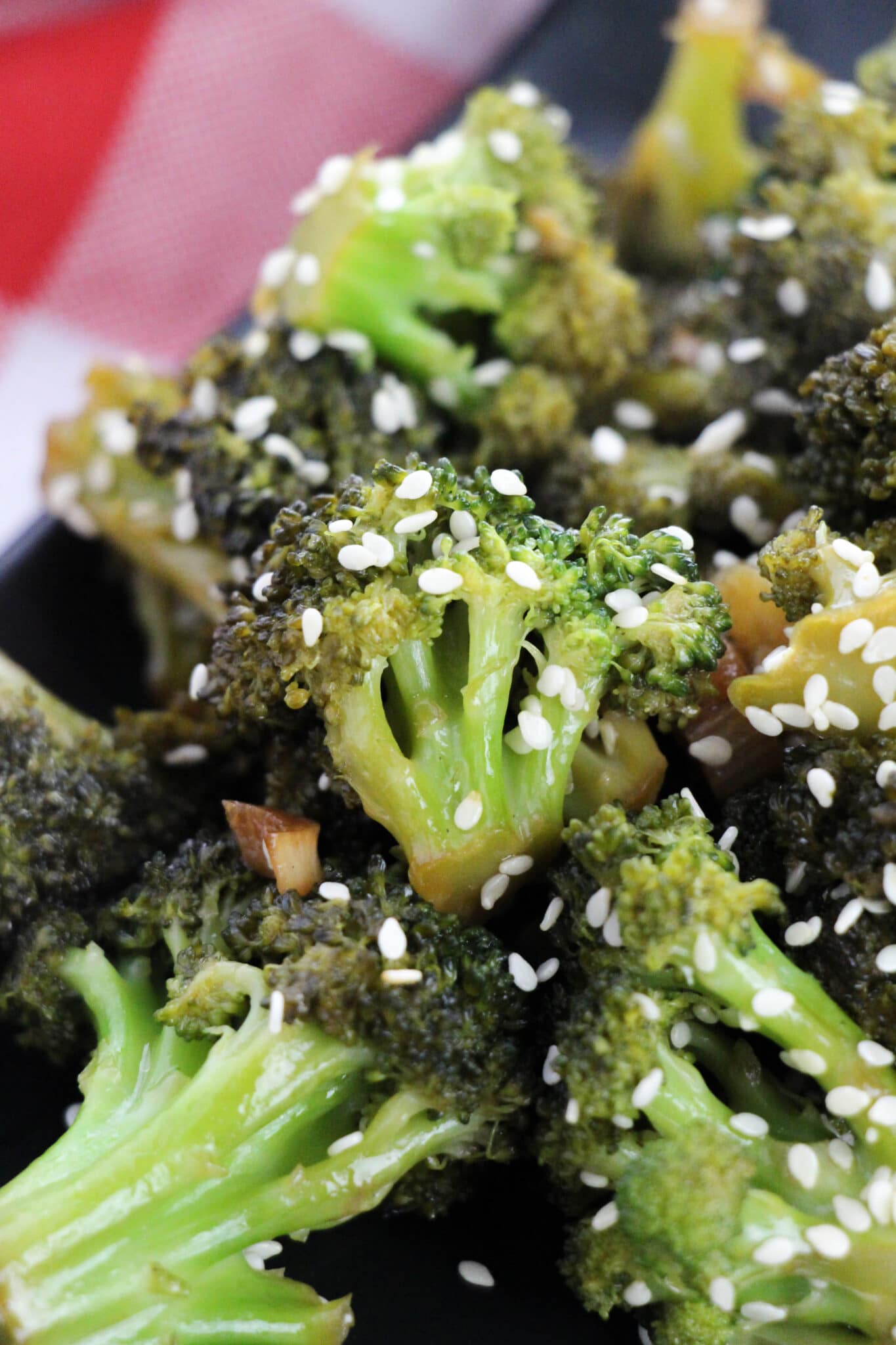 close up of Asian Style Broccoli on a black plate