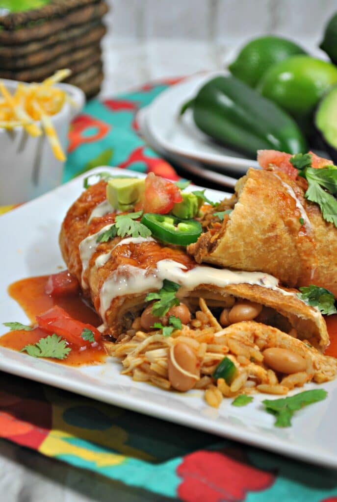 chimichangas on a white plate with toppings 