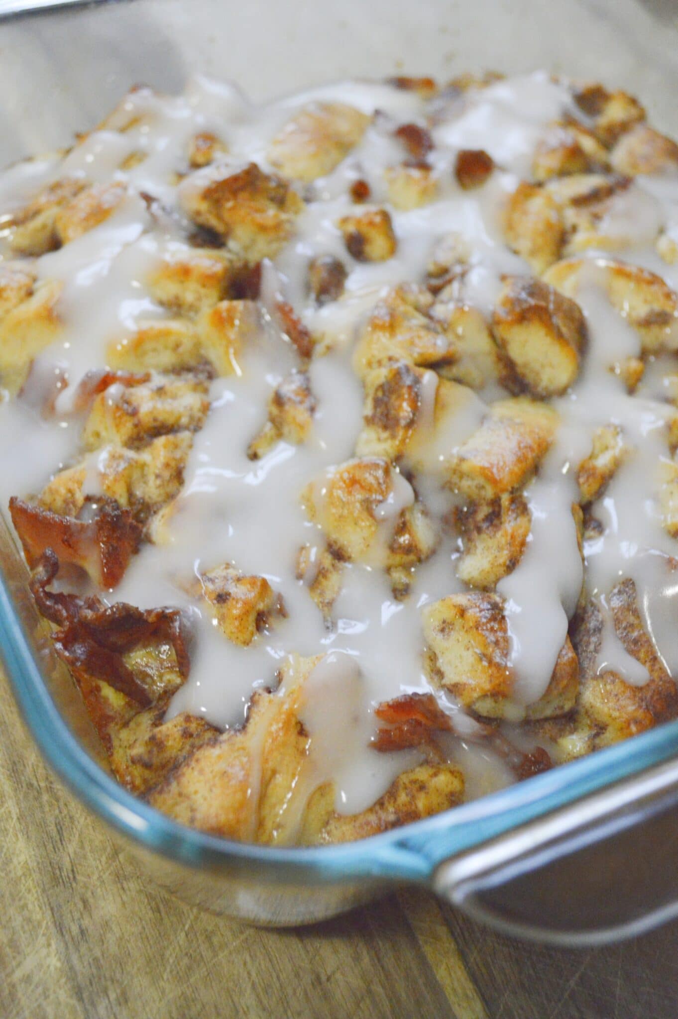 casserole dish full of cinnamon roll and bacon 