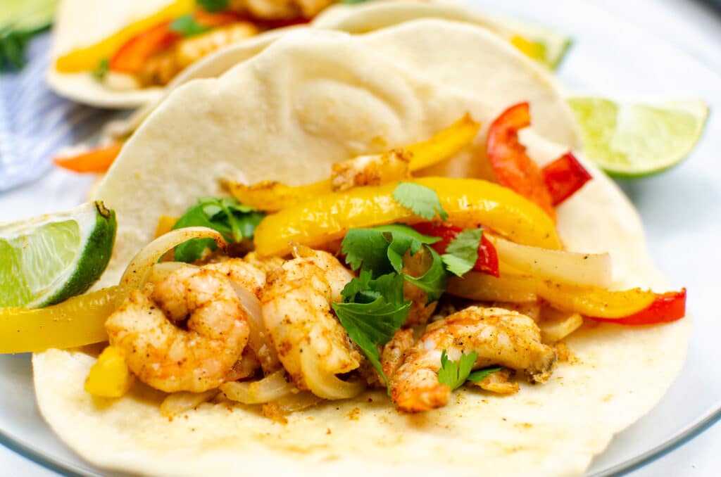 closeup of a tortilla filled with shrimp and peppers 