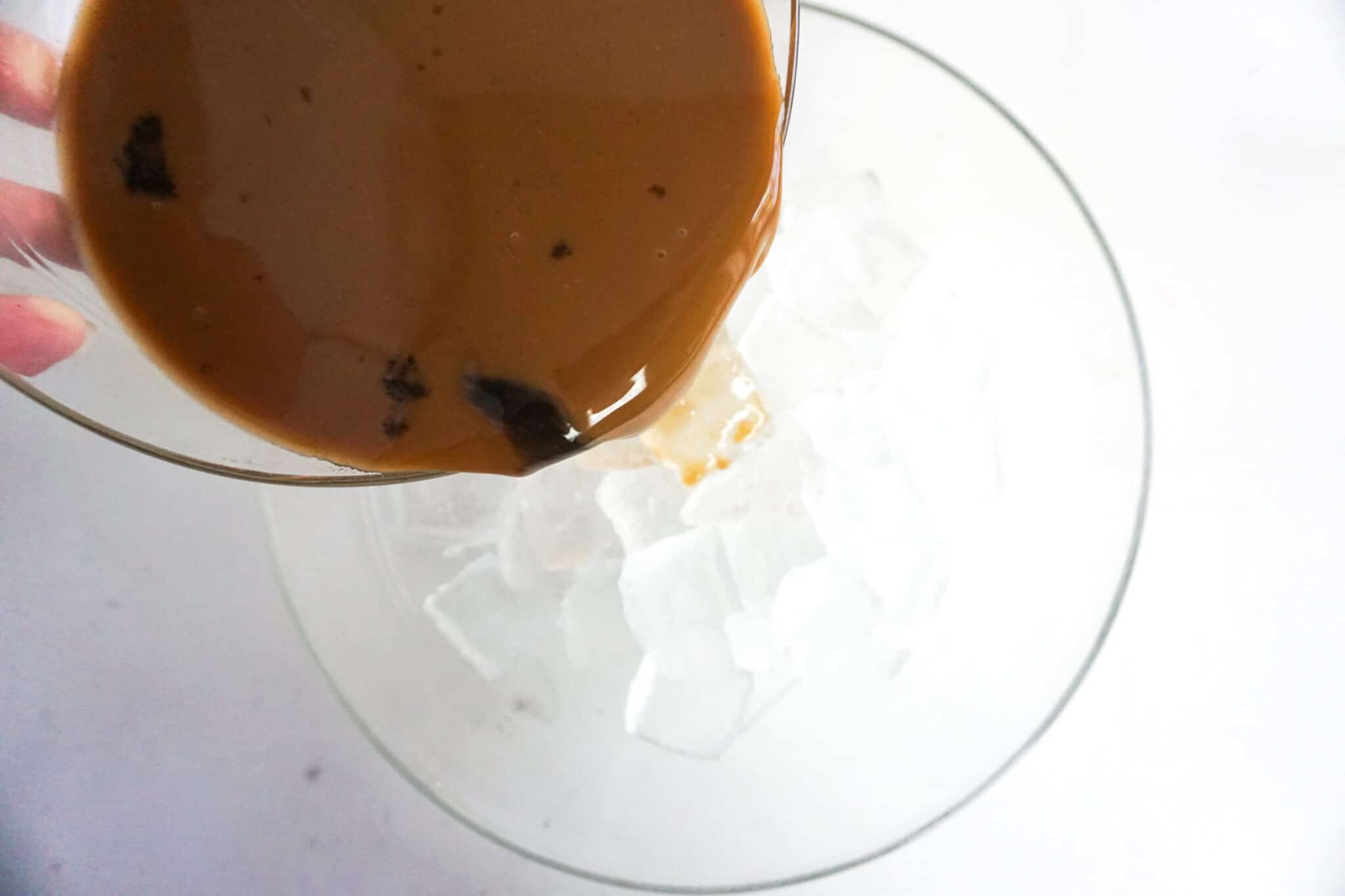 adding coffee mixture to ice and blender 