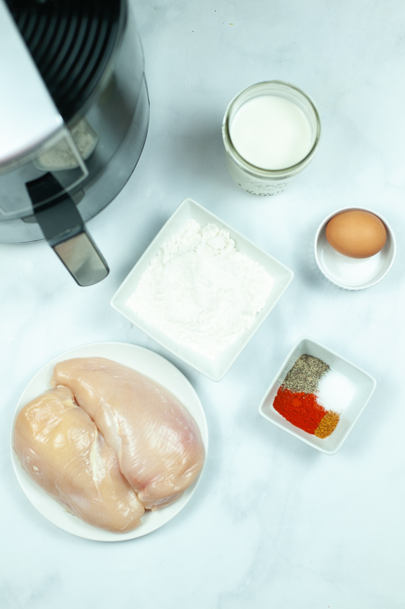 ingredients needed to make Air Fryer Chicken Tenders, and an air fryer