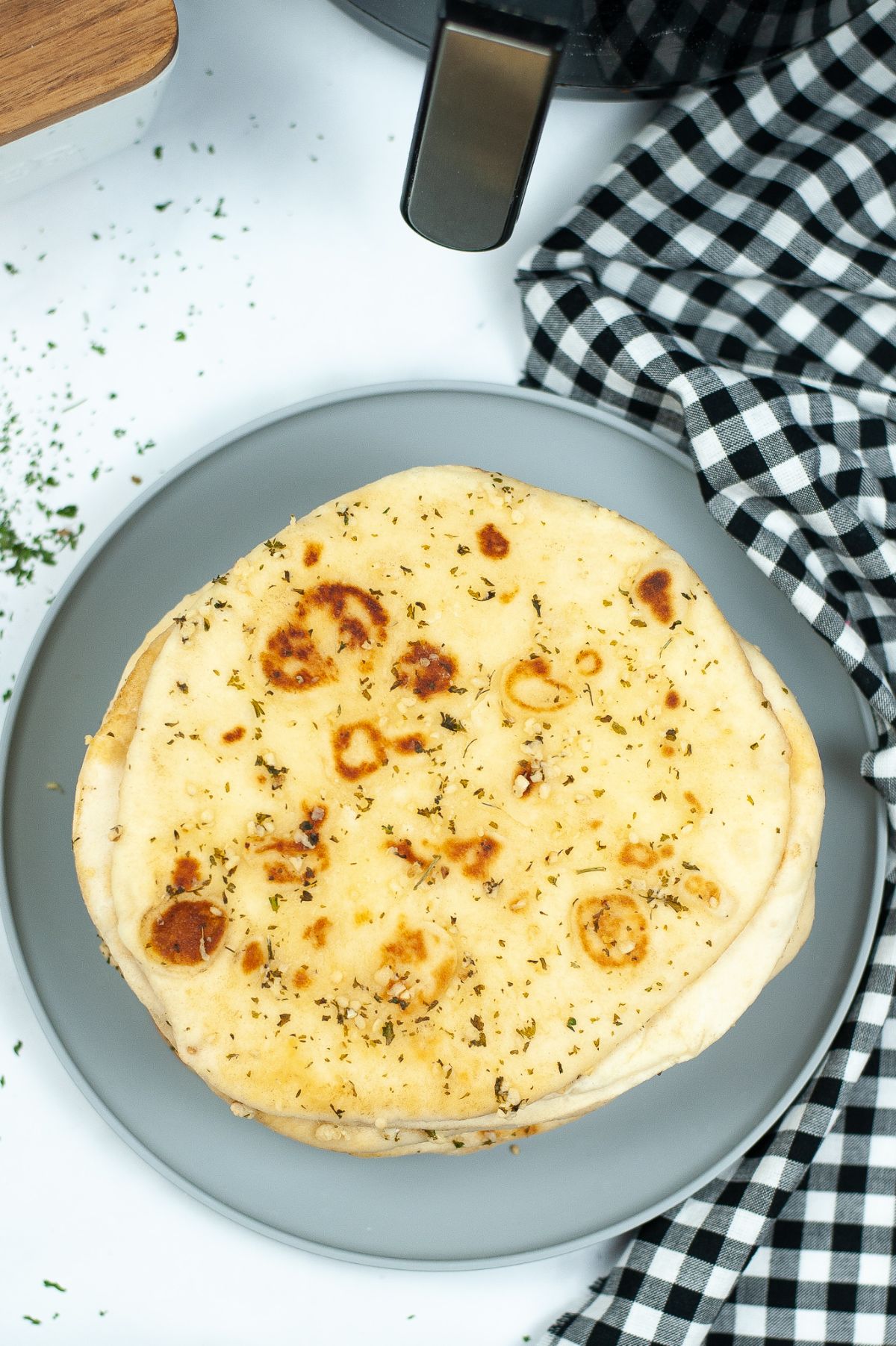 Top view of Air Fryer Garlic Naan on a gray plate.