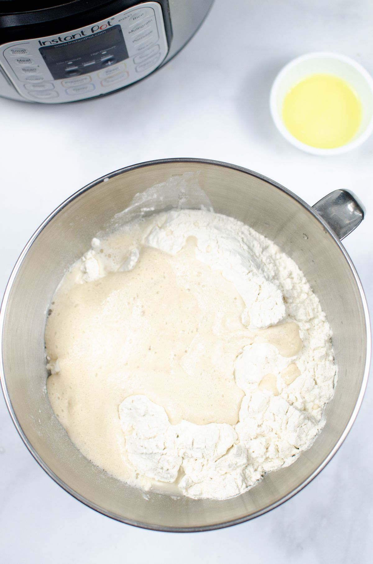 A mixing bowl with the yeast and flour mixture combined.