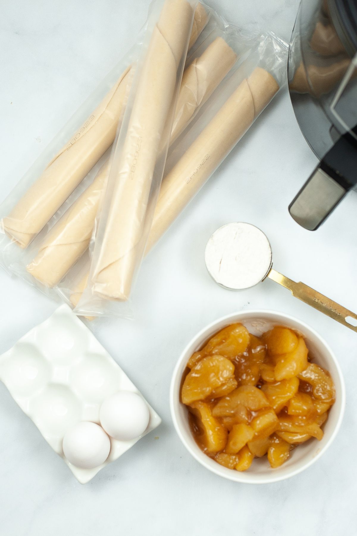 A vertical image of the ingredients needed to make Air Fryer Caramel Apple Empanadas