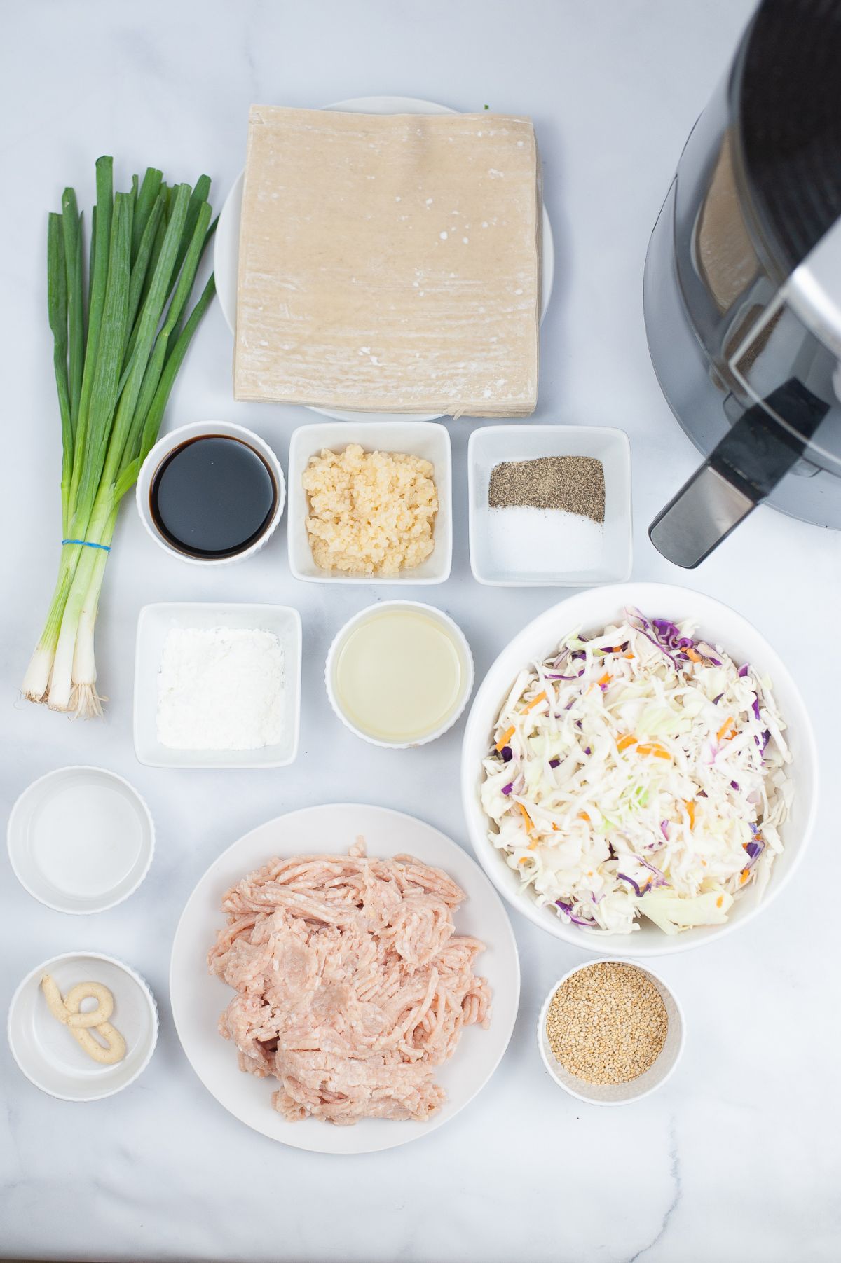 A vertical image of ingredients used to make an Air Fryer Chicken Egg Rolls.