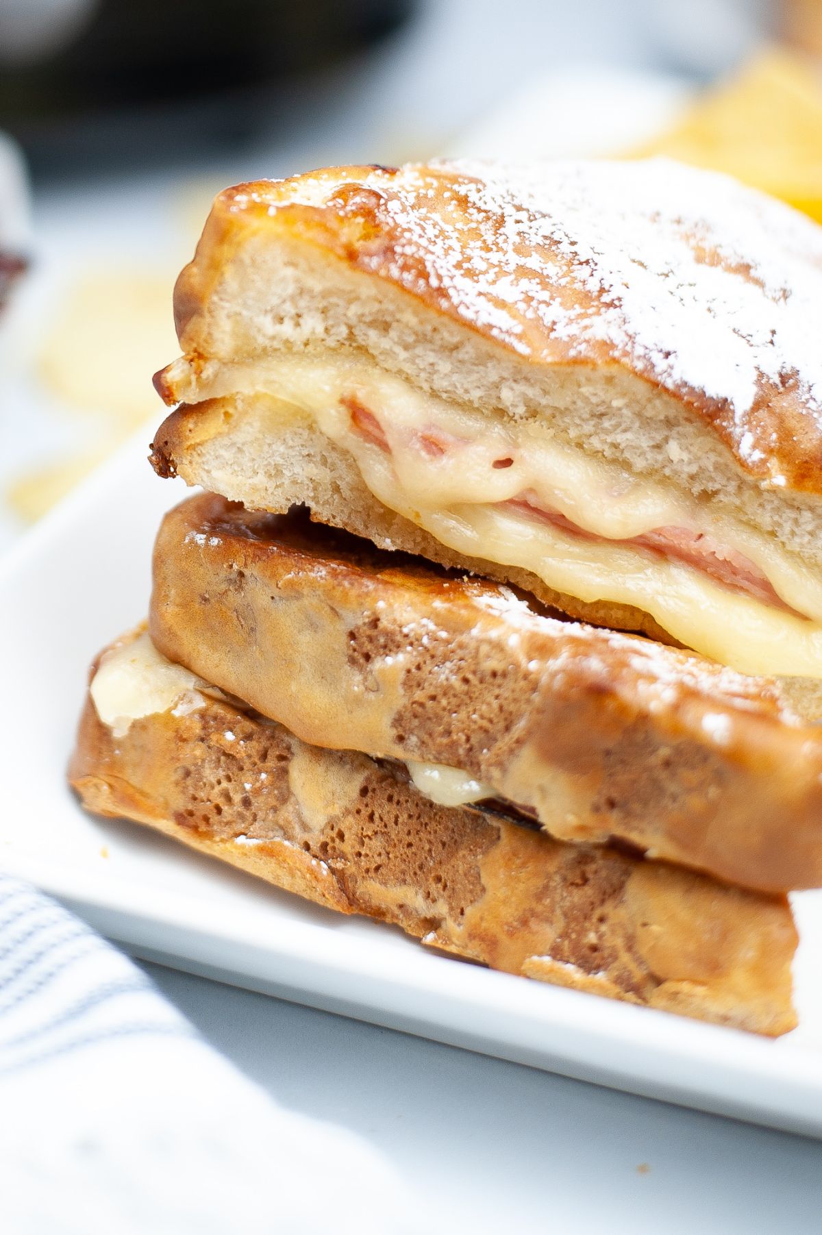 a closeup of an Air Fryer Monte Cristo highlighting the melted cheese at the middle of the sandwich.