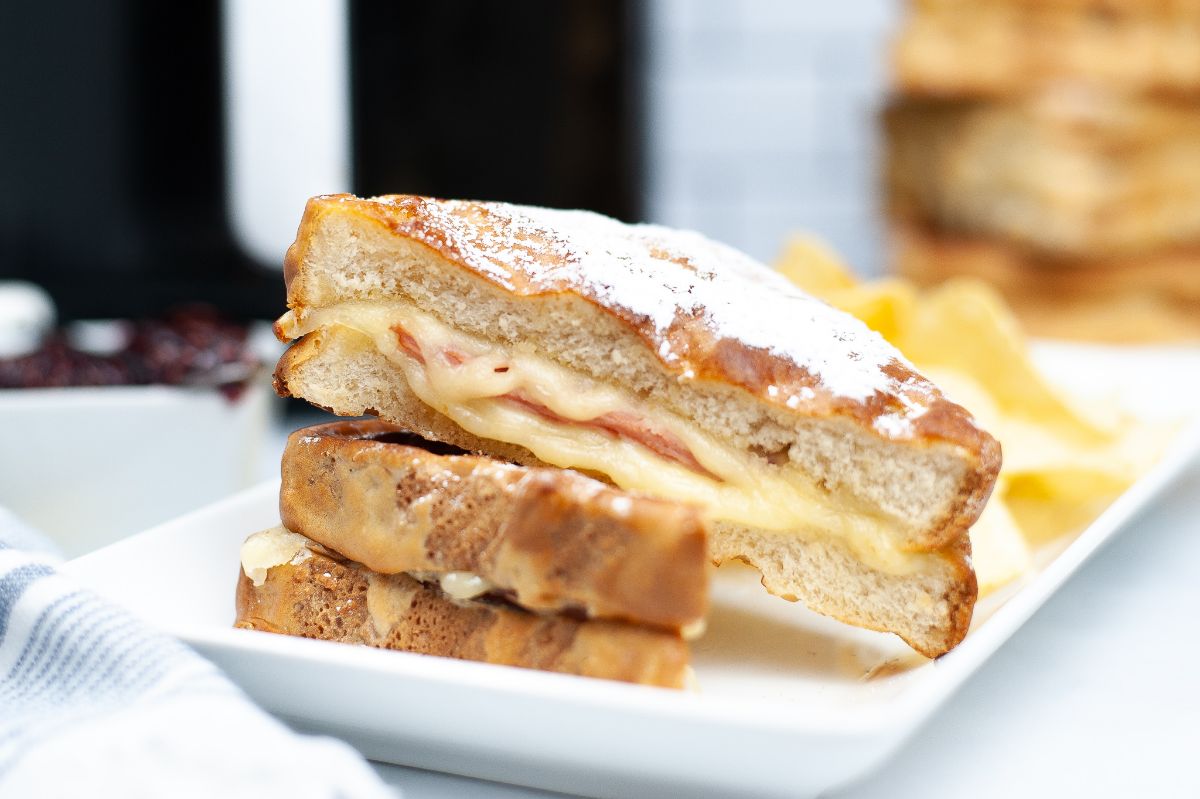 Horizontal image of the cross section of Air Fryer Monte Cristo highlighting the melted cheese and ham at the center.