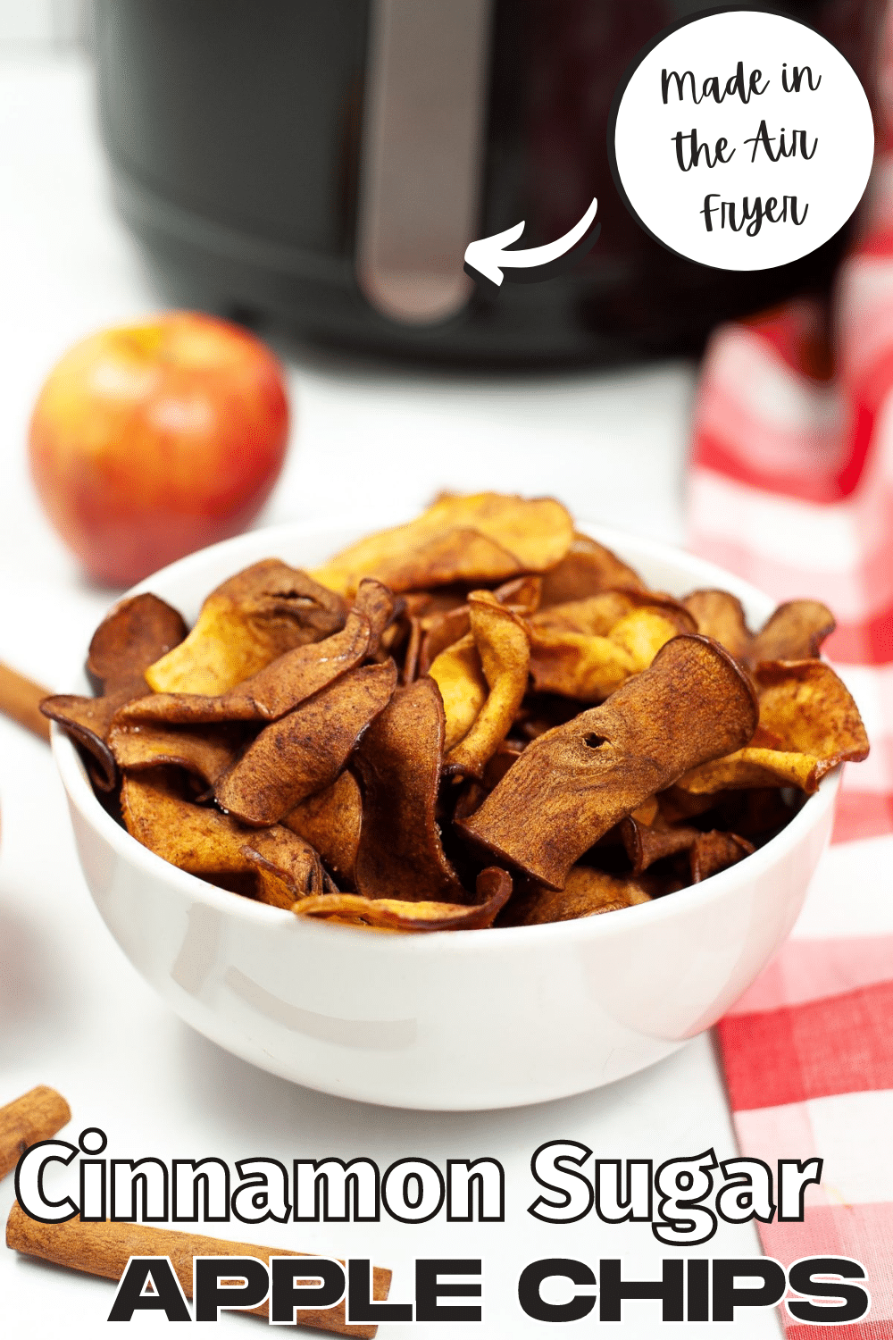 A vertical image of Air Fryer Cinnamon Apple Chips with a circled text at the top part saying "Made in the air fryer" and a larger text at the bottom saying "Cinnamon Sugar Apple Chips".