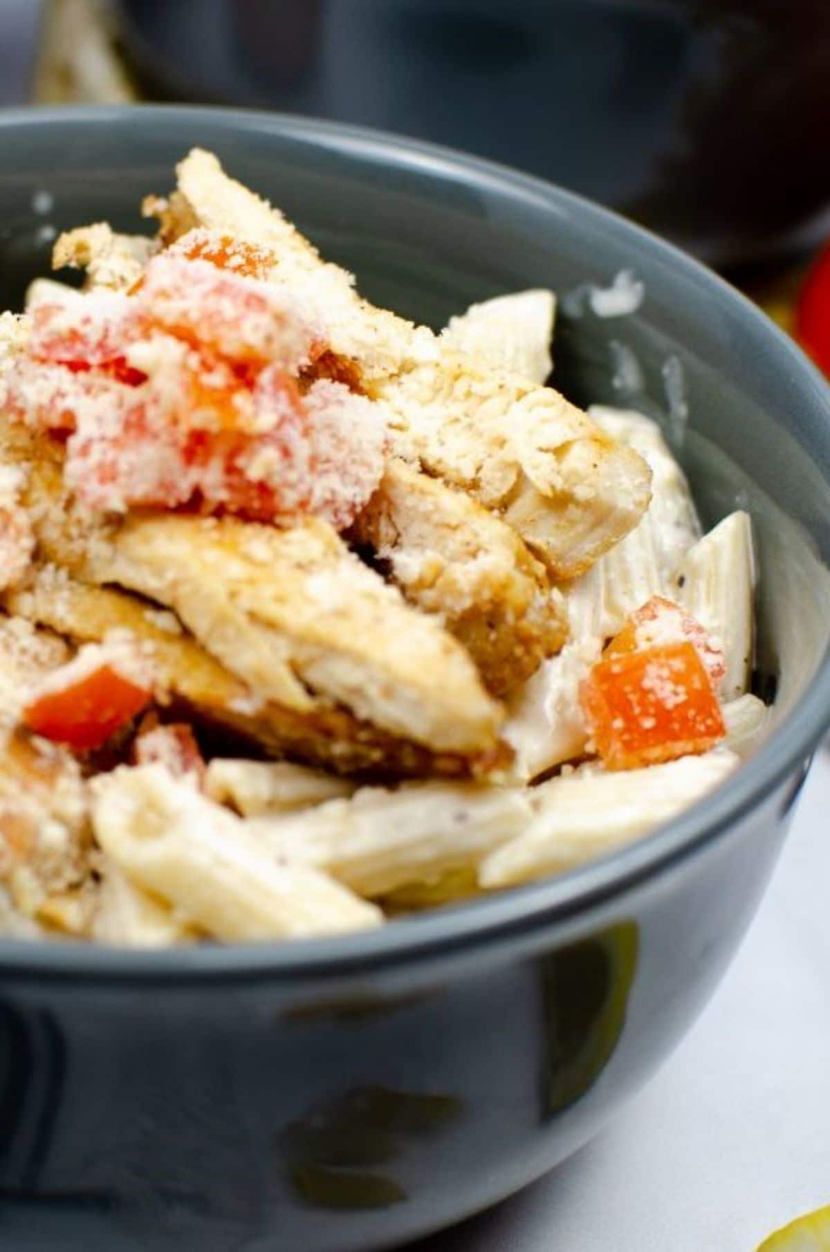 A vertical close up shot of Instant Pot Cajun Chicken Pasta in a bowl.