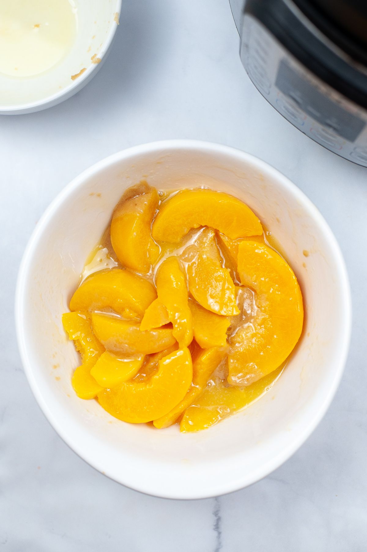 peaches in a white bowl.