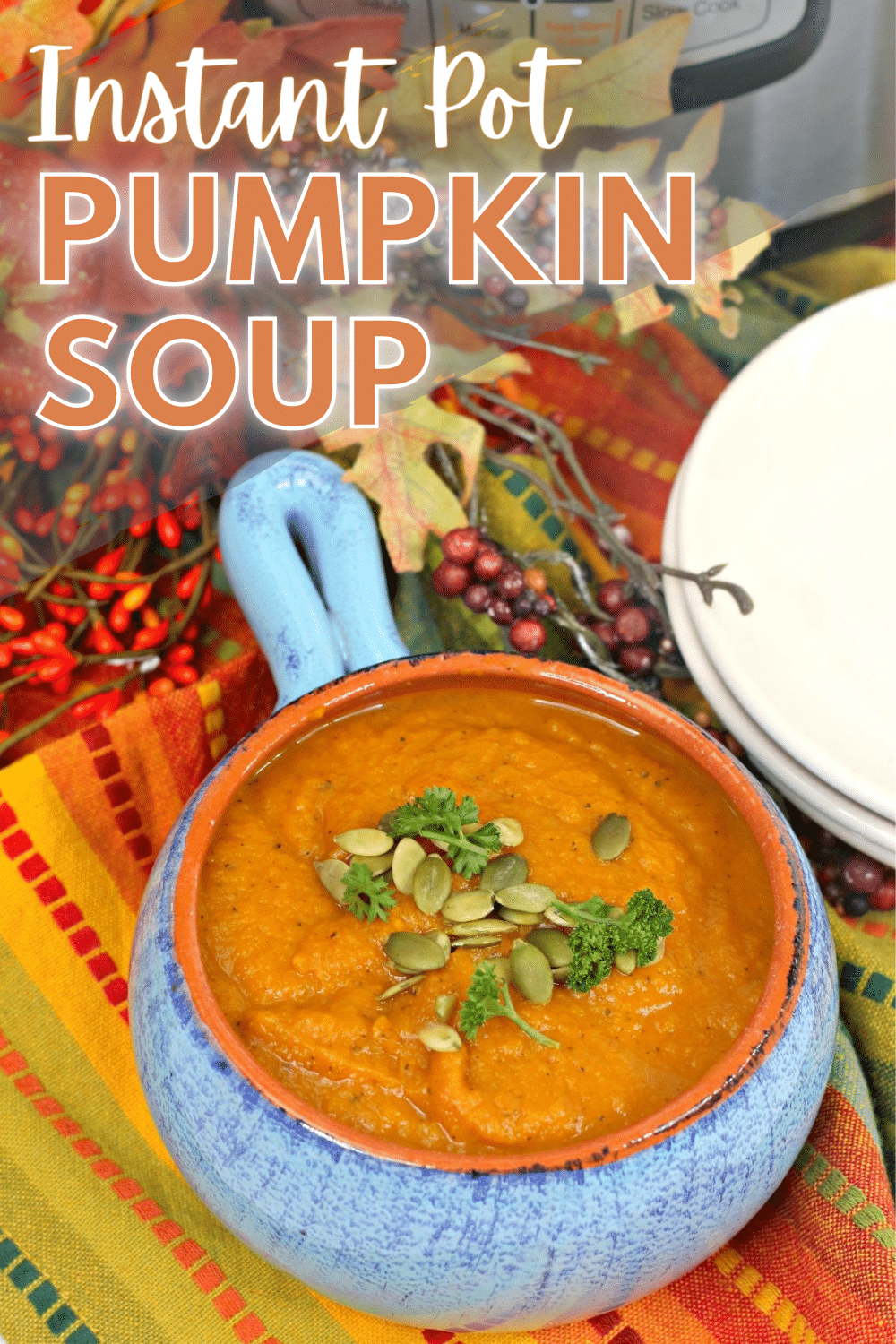 A image of Instant Pot Pumpkin Soup in a blue ceramic bowl with orange interior with a text at the top portion of the image saying "Instant Pot Pumpkin Soup".