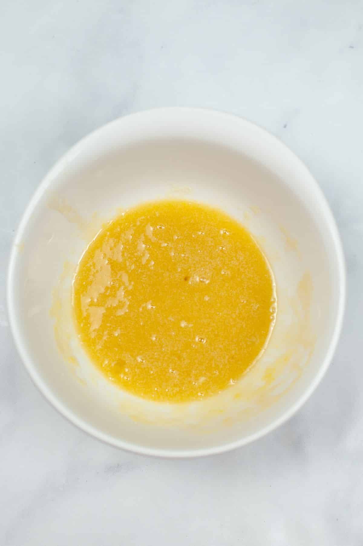 vanilla, sugar and eggs are combined in a mixing bowl
