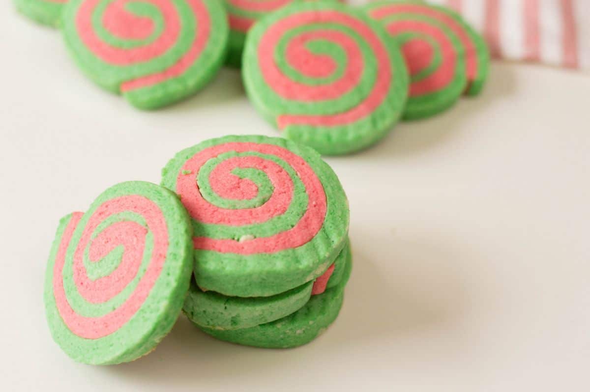 Horizontal image of stacked Christmas Pinwheel Cookies with some of them blurred in the background.