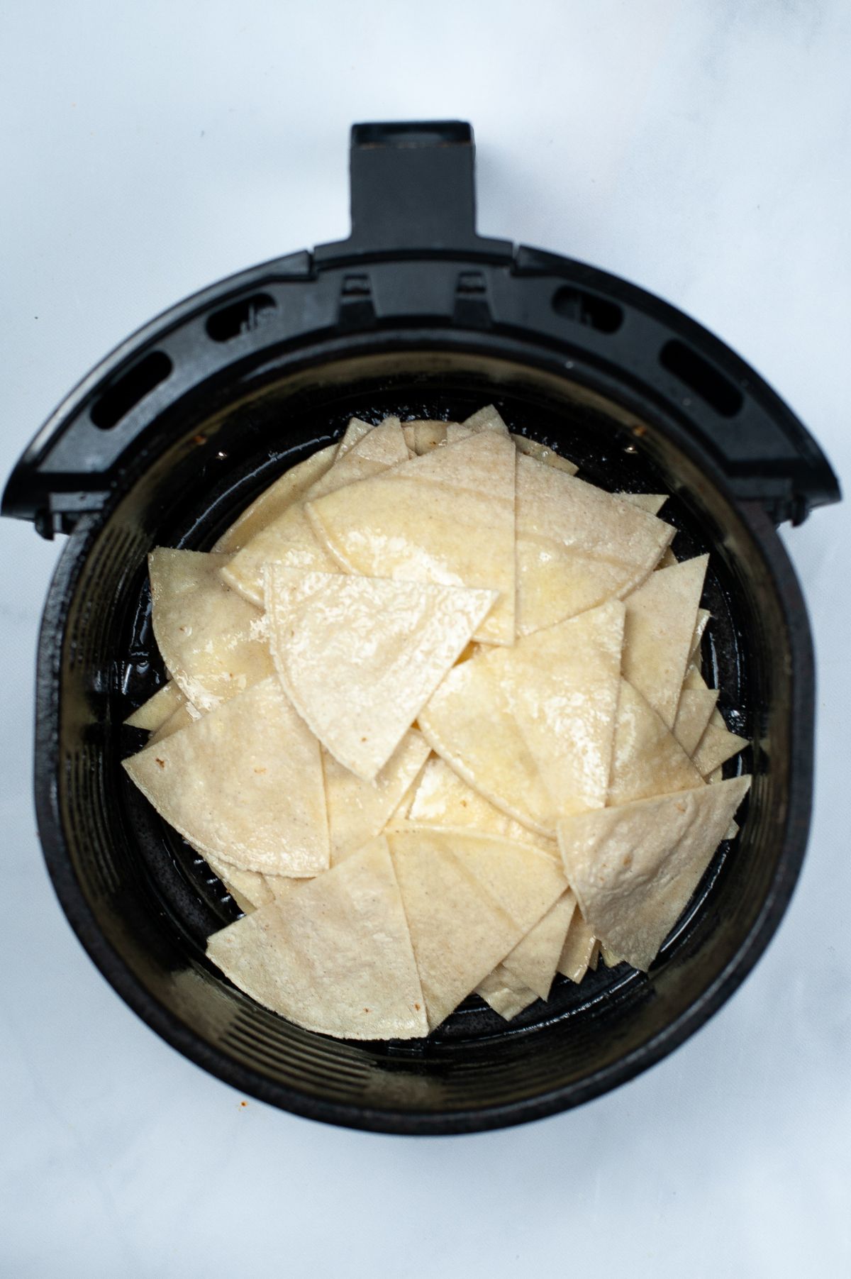 Tortillas in the air fryer basket.