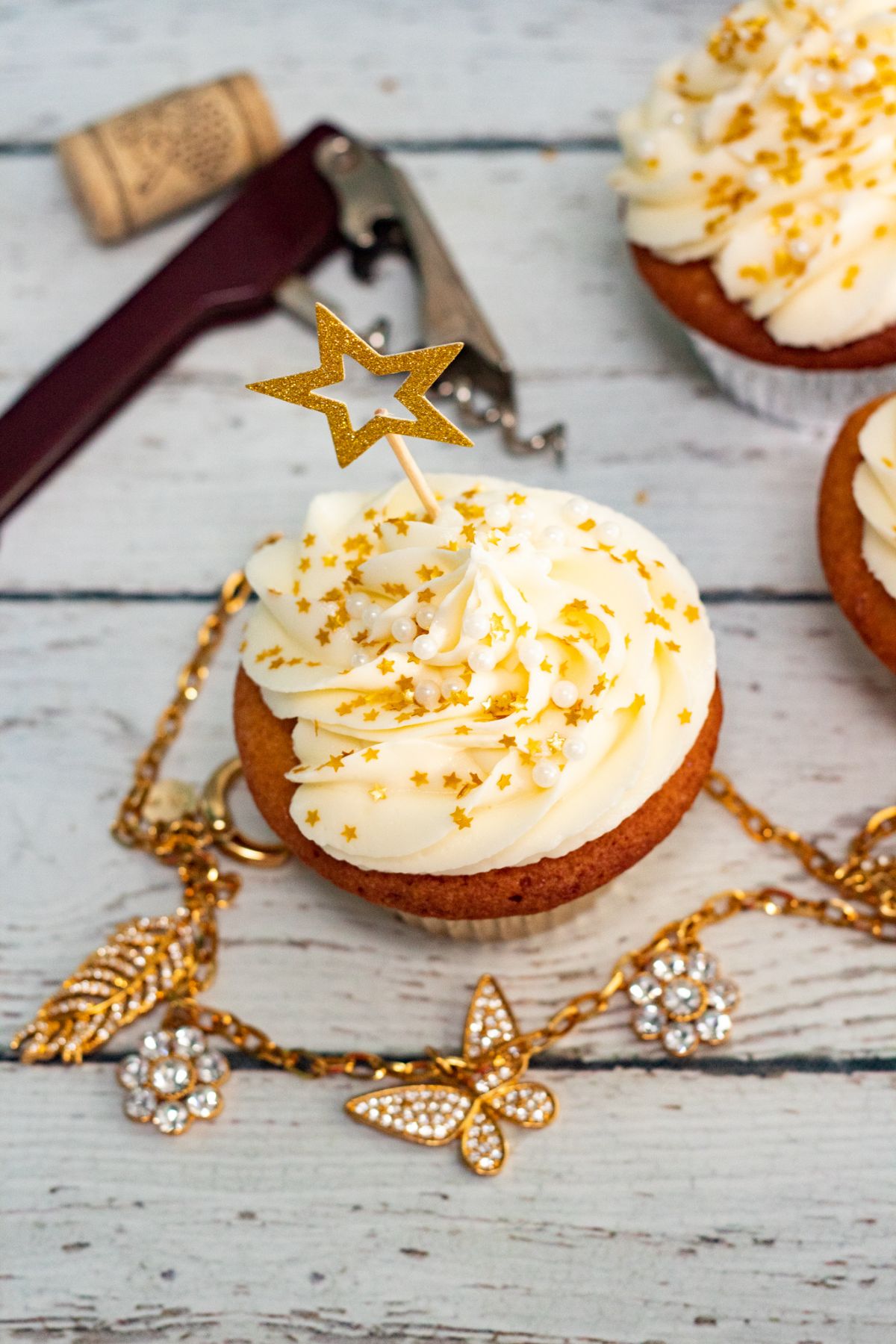 Overhead shot of Champagne cupcakes decorated with gold stars.