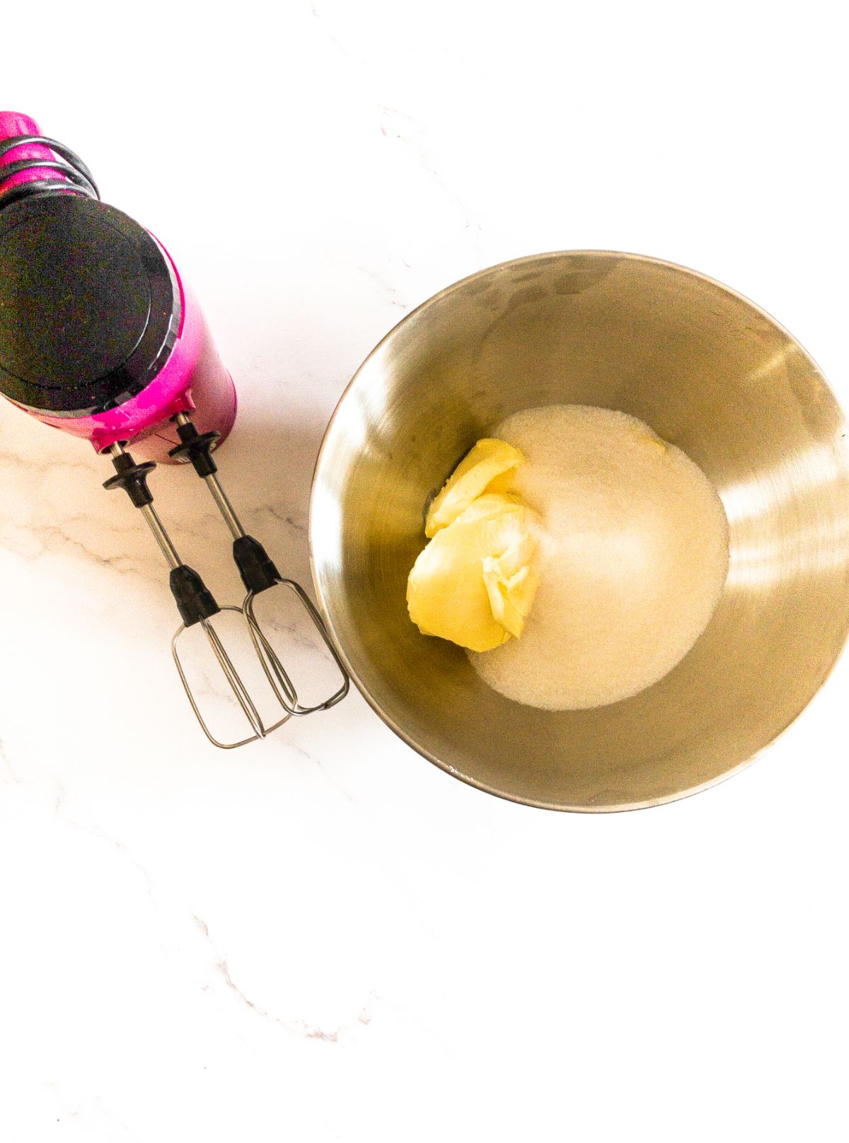 An image of butter and sugar in a mixing bowl ready to be whisked.