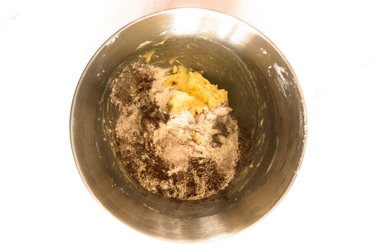 An image of the dry ingredients being mixed into the wet ingredients in a mixing bowl.