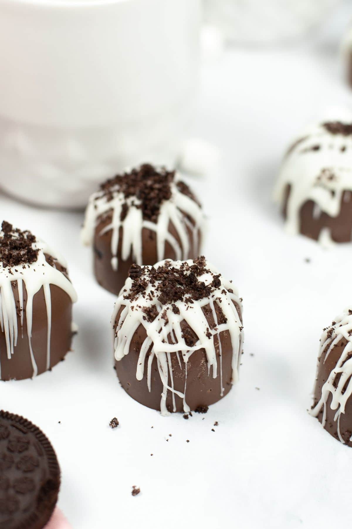 A close up view of Cookies and Cream Hot Cocoa Bombs highlighting the crushed cookie topping.