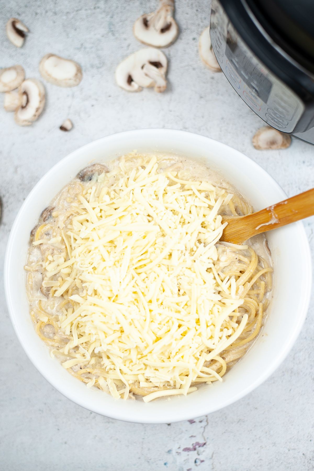 Cooked Instant Pot Chicken Tetrazzini topped with cheese ready for mixing.