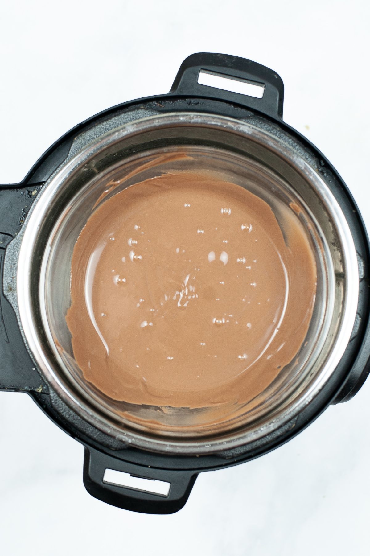 Brown candy melts being melted in an Instant Pot.