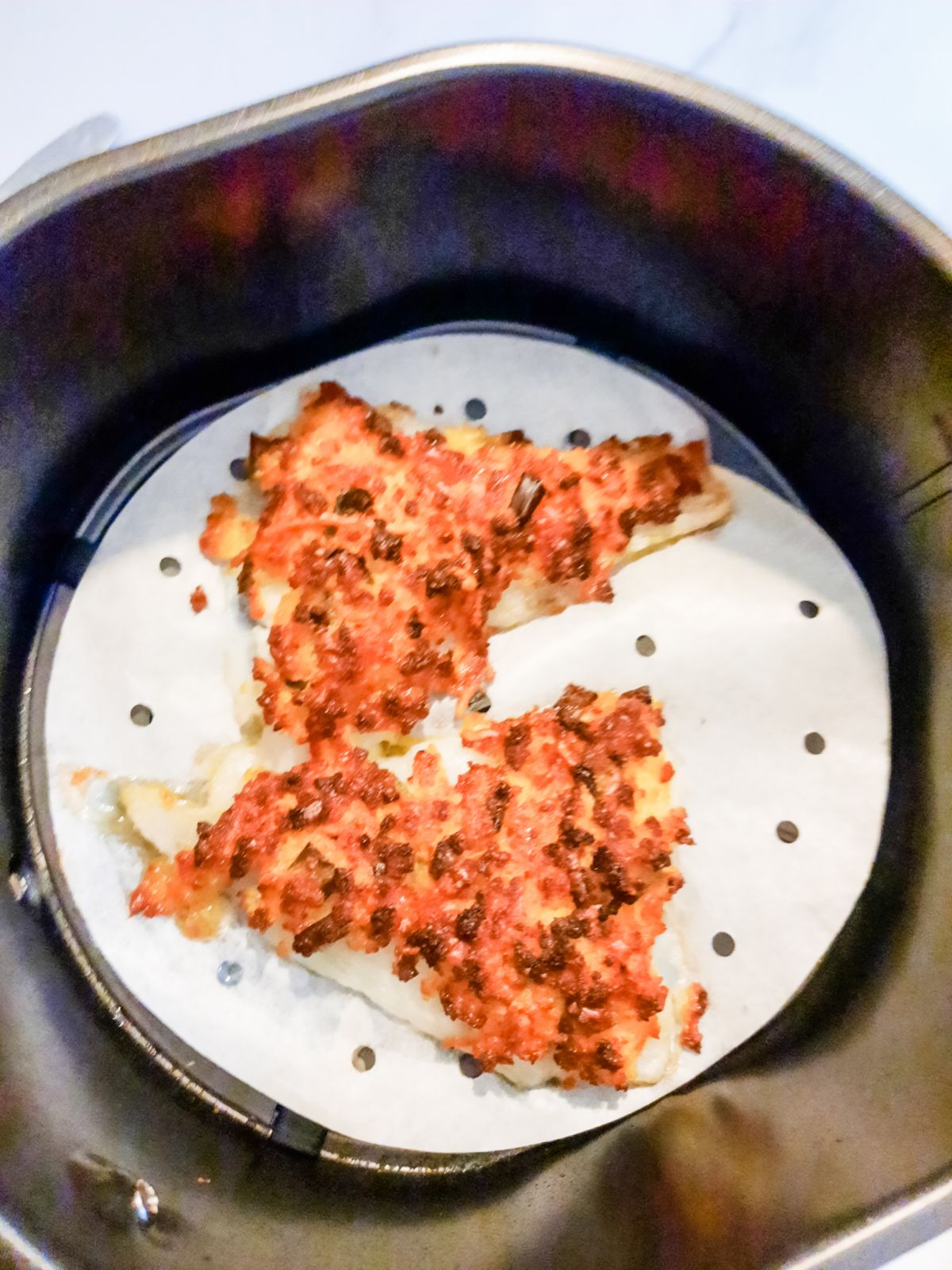 Fried Parmesan cod in an air fryer.